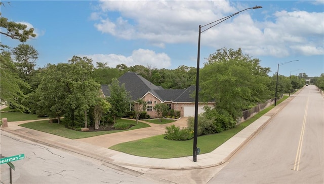 exterior space featuring street lights, curbs, and sidewalks