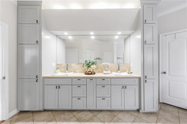 bathroom with decorative backsplash, double vanity, and a sink