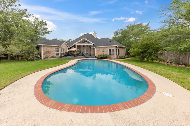 view of pool with a yard, fence, a patio area, and a fenced in pool