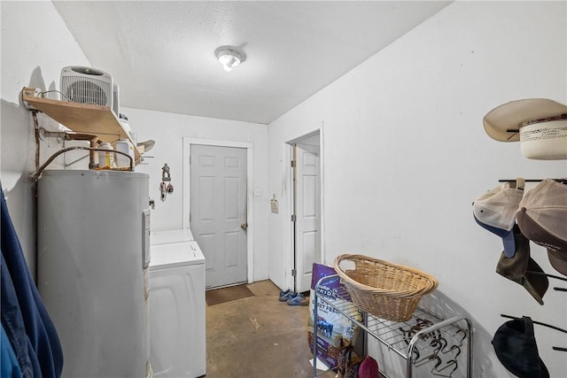 laundry area with washing machine and clothes dryer, a textured ceiling, and water heater