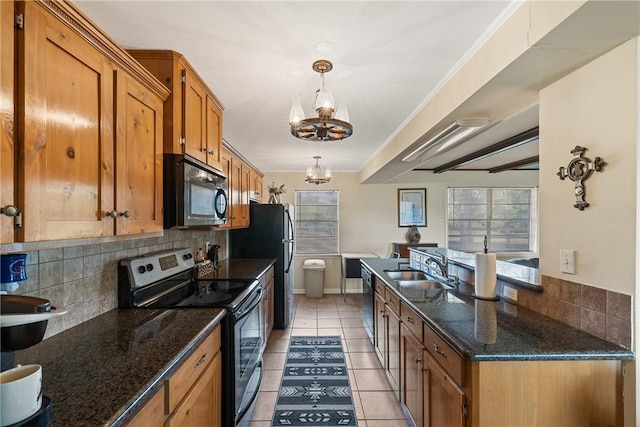 kitchen with tasteful backsplash, ornamental molding, black appliances, light tile patterned floors, and a notable chandelier