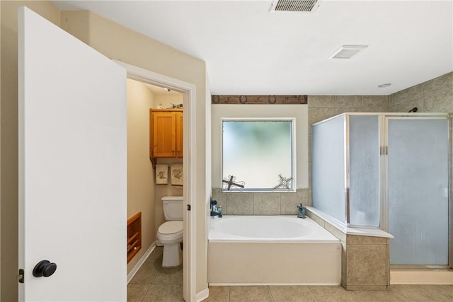 bathroom featuring tile patterned flooring, separate shower and tub, and toilet