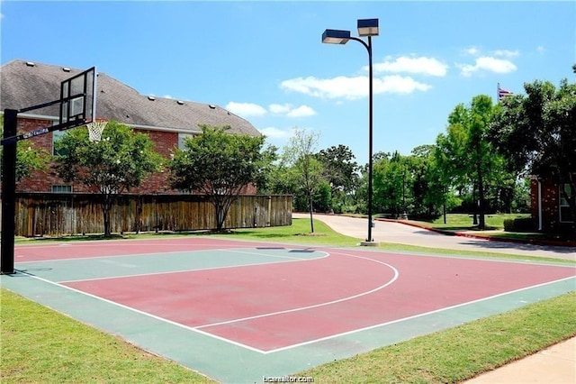 view of basketball court featuring a lawn