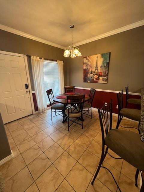 tiled dining area featuring a notable chandelier and ornamental molding