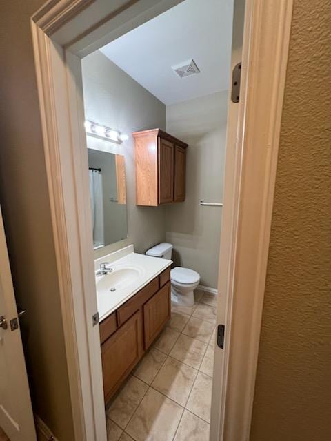 bathroom with tile patterned floors, toilet, and vanity