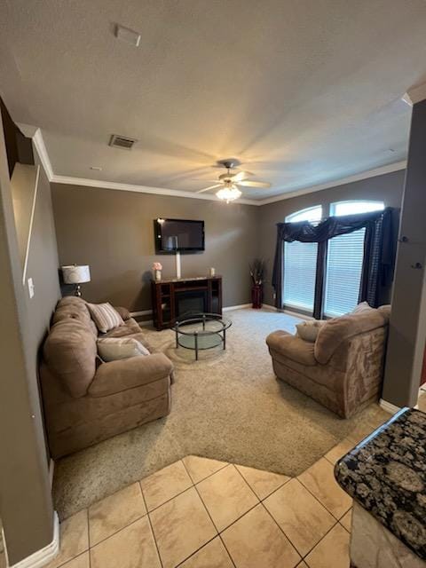 tiled living room featuring crown molding and ceiling fan