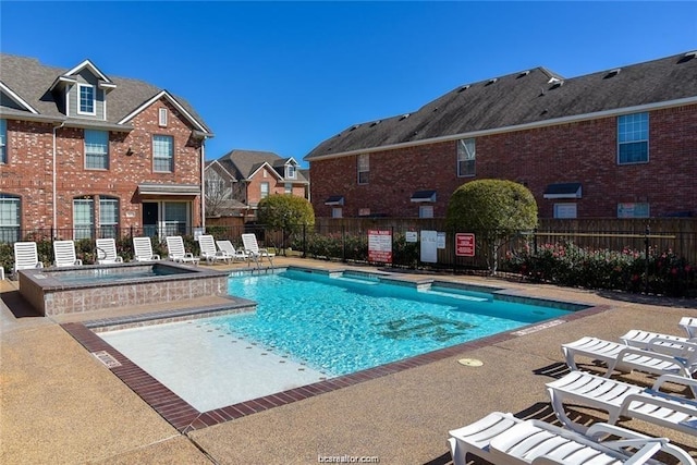 view of pool with a community hot tub and a patio area