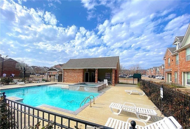 view of pool with a patio and a community hot tub