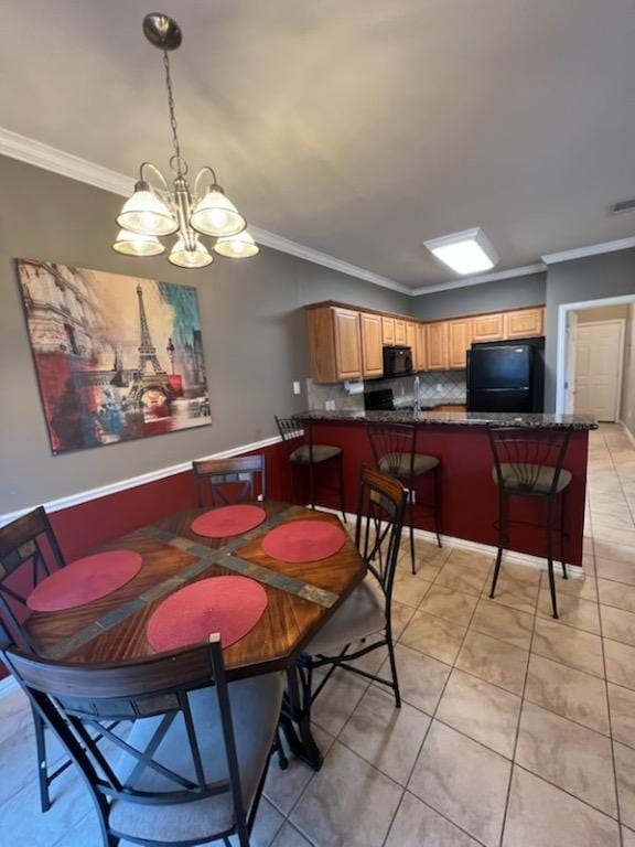 dining room featuring ornamental molding and light tile patterned floors