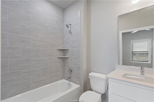 full bathroom featuring toilet, tiled shower / bath, and vanity