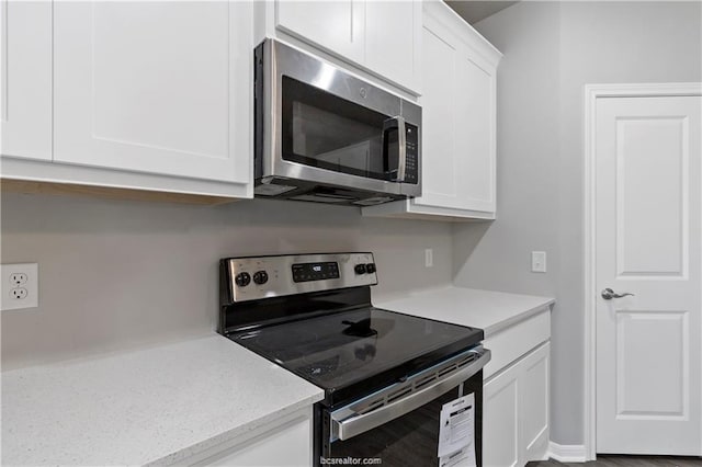 kitchen with appliances with stainless steel finishes and white cabinetry