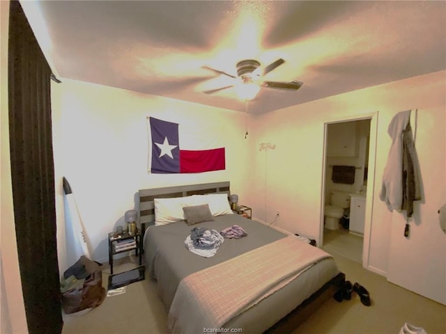 bedroom featuring connected bathroom, ceiling fan, and light colored carpet