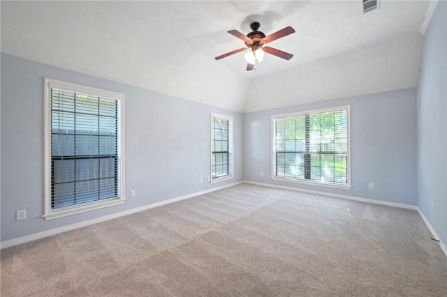 spare room with visible vents, ceiling fan, carpet, and plenty of natural light