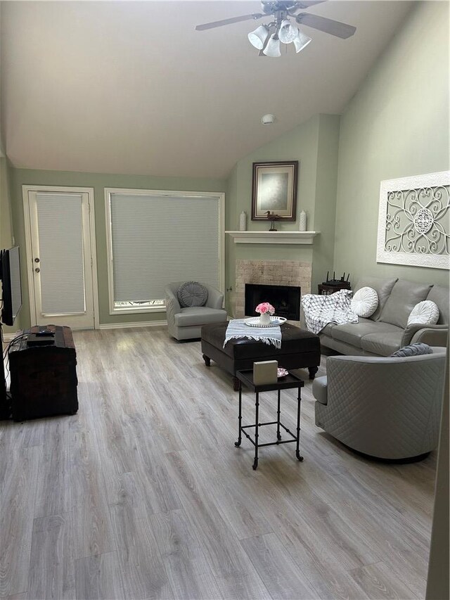 2020 Carter Lake Dr, College Station, TX 77845 - living room featuring lofted ceiling, a ceiling fan, wood finished floors, and a fireplace