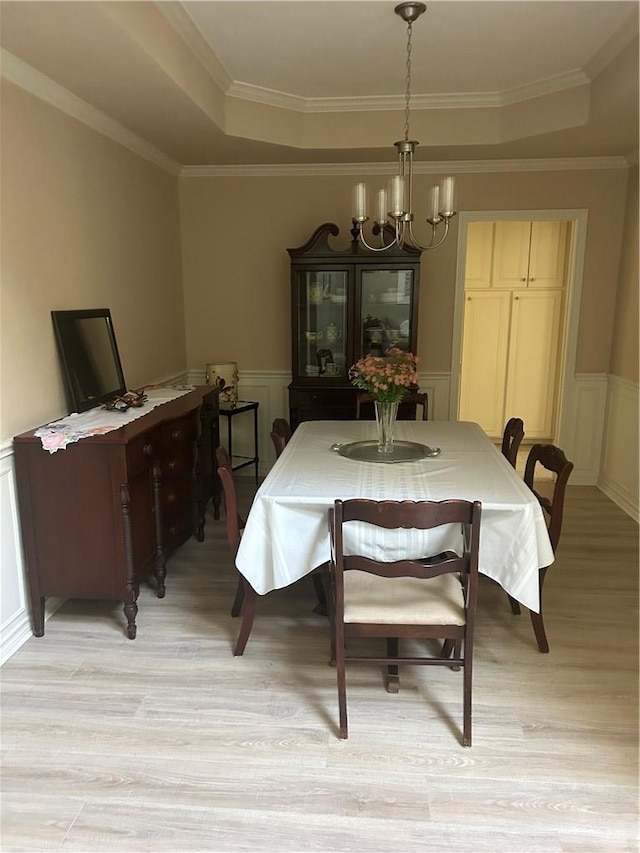 2020 Carter Lake Dr, College Station, TX 77845 - dining area with a chandelier, light wood-type flooring, a decorative wall, wainscoting, and ornamental molding