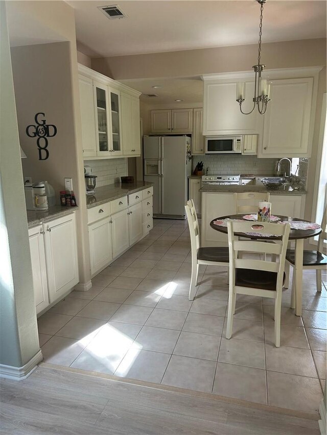2020 Carter Lake Dr, College Station, TX 77845 - dining space featuring a chandelier and light tile patterned flooring