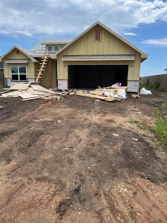 436 Brazos Bnd, Snook, TX 77879 - unfinished property with board and batten siding, dirt driveway, and an attached garage
