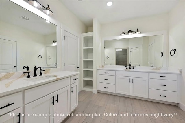 436 Brazos Bnd, Snook, TX 77879 - bathroom with two vanities and recessed lighting