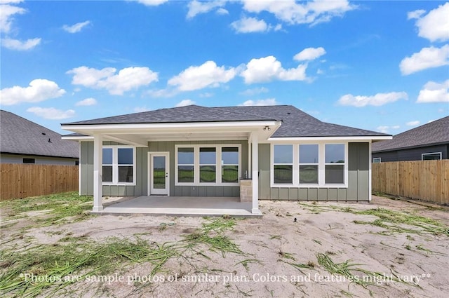 436 Brazos Bnd, Snook, TX 77879 - back of property with board and batten siding, a patio, a fenced backyard, and roof with shingles