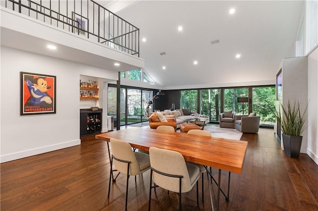 23 Forest Dr, College Station, TX 77840 - dining space with high vaulted ceiling, a bar, healthy amount of natural light, baseboards, and recessed lighting