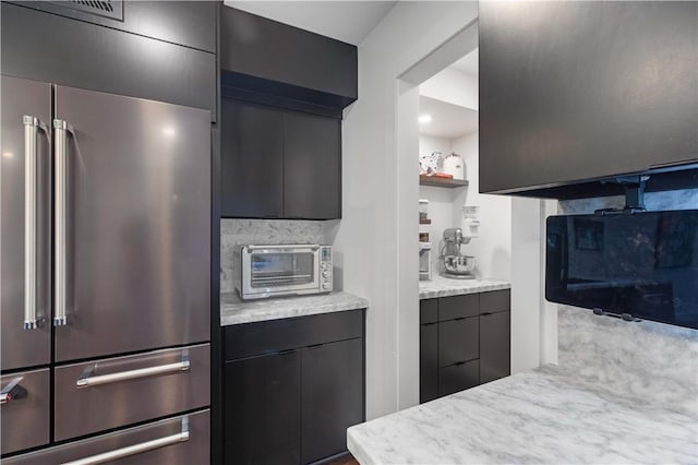 23 Forest Dr, College Station, TX 77840 - kitchen with high end refrigerator, modern cabinets, decorative backsplash, and light stone countertops