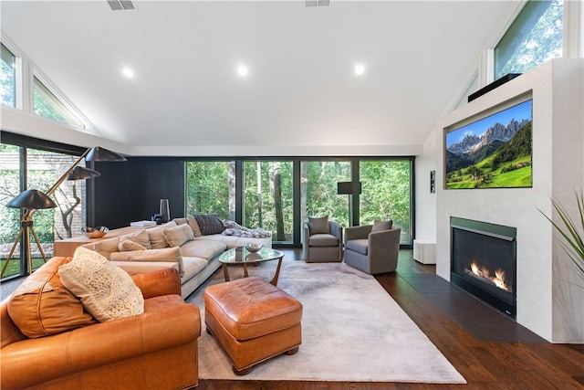 23 Forest Dr, College Station, TX 77840 - living room with high vaulted ceiling, a fireplace with flush hearth, dark wood-style floors, and recessed lighting