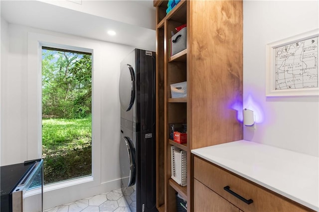 23 Forest Dr, College Station, TX 77840 - kitchen featuring estacked washer and dryer, light countertops, and brown cabinetry