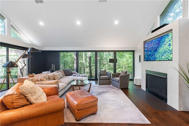 23 Forest Dr, College Station, TX 77840 - living area with high vaulted ceiling, a fireplace with flush hearth, dark wood-style flooring, and recessed lighting