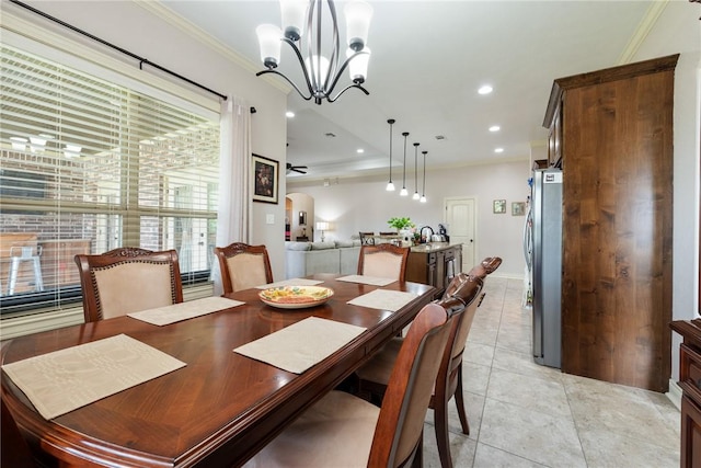 tiled dining space with ceiling fan with notable chandelier and crown molding