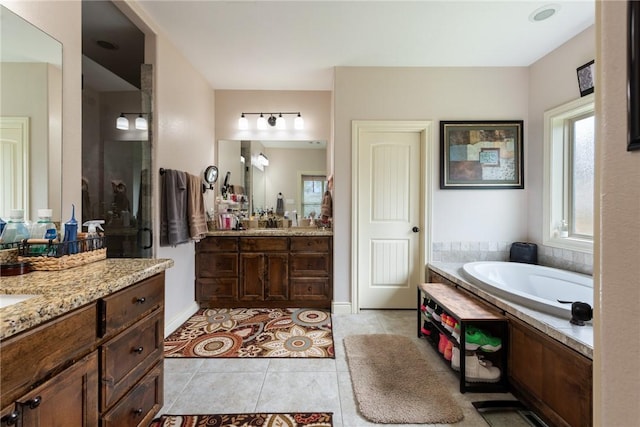 bathroom featuring a tub, tile patterned flooring, and vanity