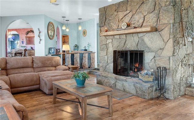 living room with hardwood / wood-style floors and a fireplace