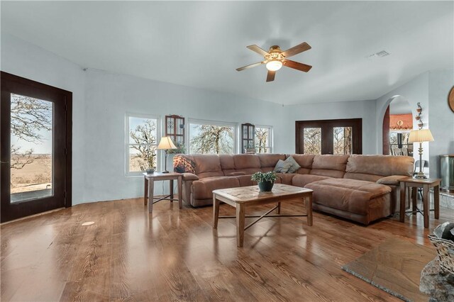 living room featuring hardwood / wood-style floors and ceiling fan