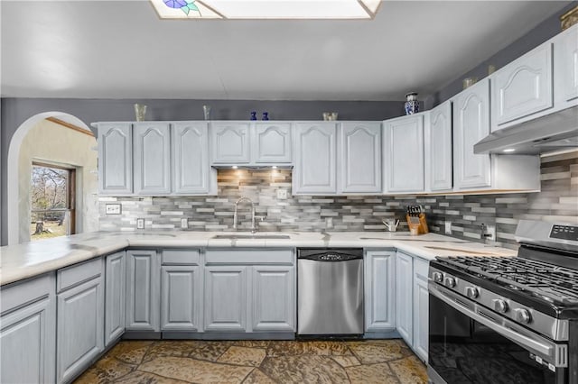 kitchen featuring appliances with stainless steel finishes, sink, and white cabinets