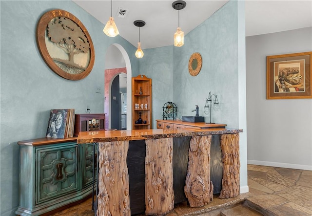 bar featuring hanging light fixtures