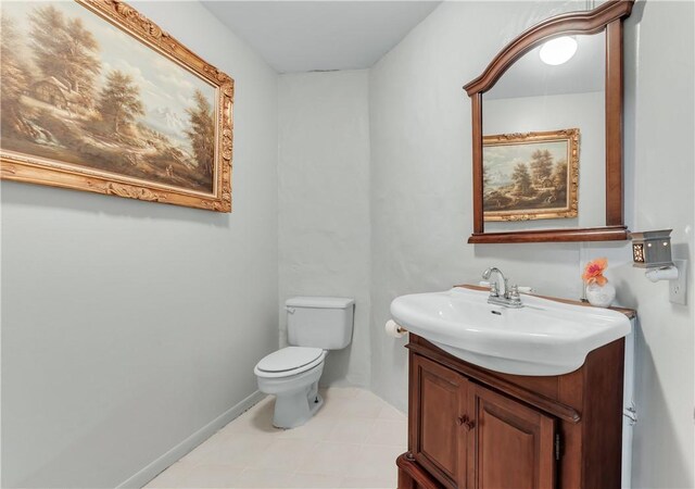 bathroom featuring vanity, toilet, and tile patterned flooring