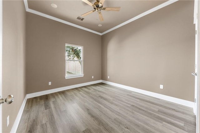 spare room with light hardwood / wood-style flooring, ornamental molding, and ceiling fan