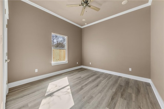 spare room featuring crown molding, ceiling fan, and light wood-type flooring