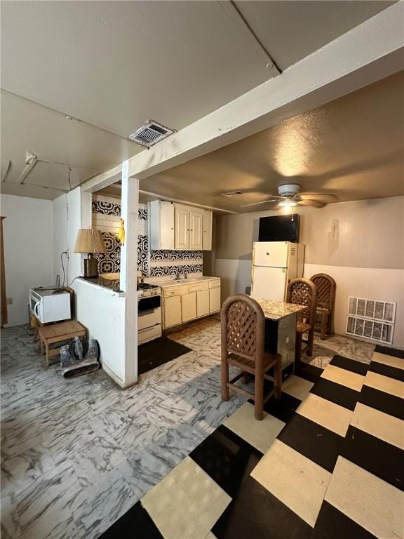 interior space featuring white refrigerator and sink