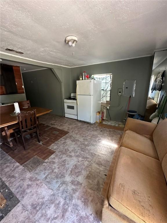 living room featuring a textured ceiling and electric panel