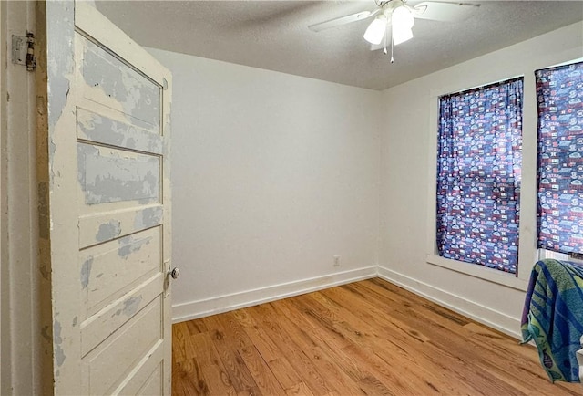 403N Banks St, Caldwell, TX 77836 - spare room featuring light wood-style floors, ceiling fan, baseboards, and a textured ceiling