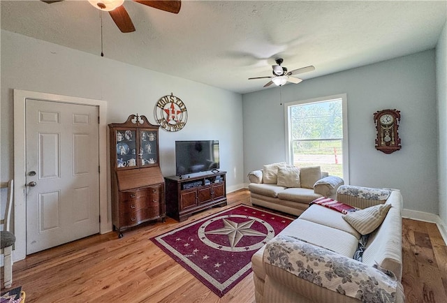 403N Banks St, Caldwell, TX 77836 - living area with a ceiling fan, light wood-style floors, and baseboards