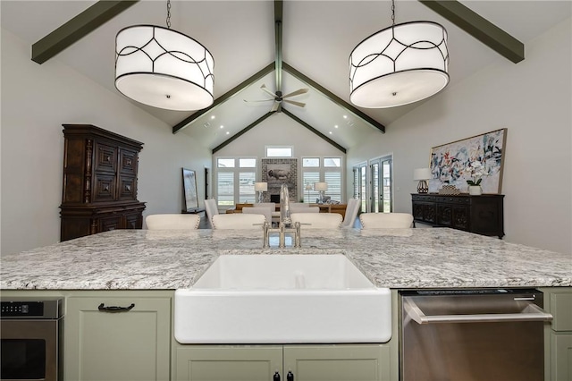 kitchen with beamed ceiling, a sink, open floor plan, green cabinets, and ceiling fan