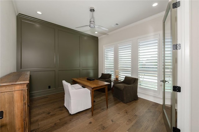 office with visible vents, dark wood finished floors, ceiling fan, crown molding, and a decorative wall