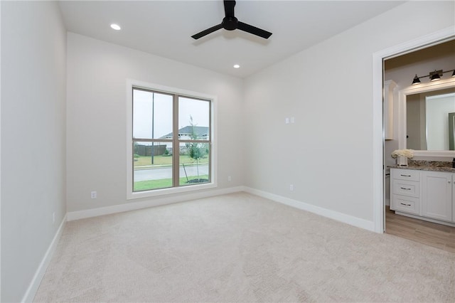 unfurnished bedroom with recessed lighting, baseboards, and light carpet