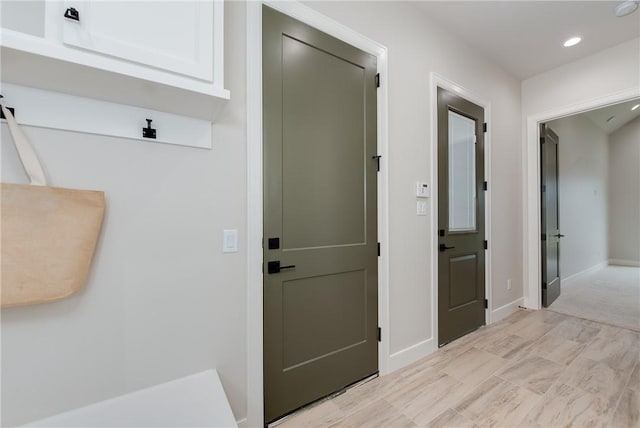 corridor with recessed lighting and baseboards