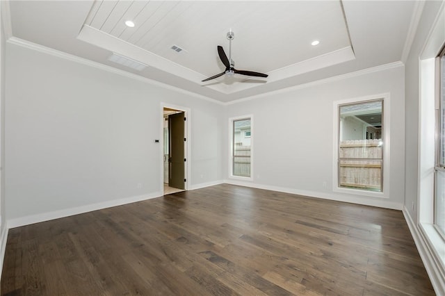 unfurnished room featuring a tray ceiling, visible vents, and crown molding