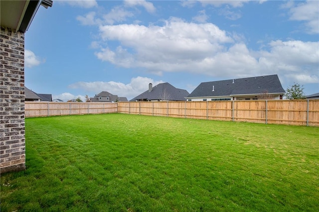 view of yard with a fenced backyard