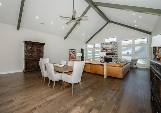 dining room with ceiling fan, beamed ceiling, high vaulted ceiling, and dark wood-style floors