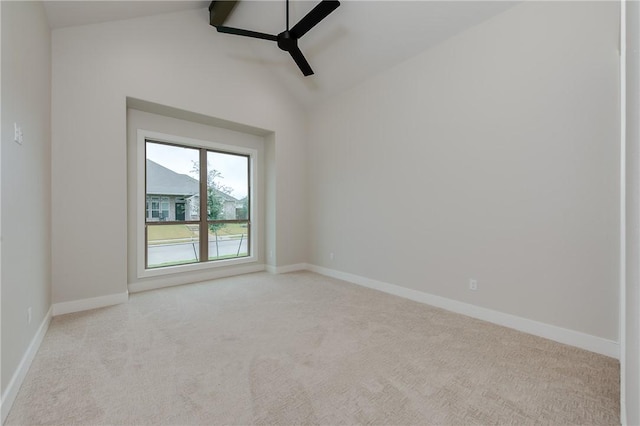 empty room with lofted ceiling, carpet, baseboards, and ceiling fan