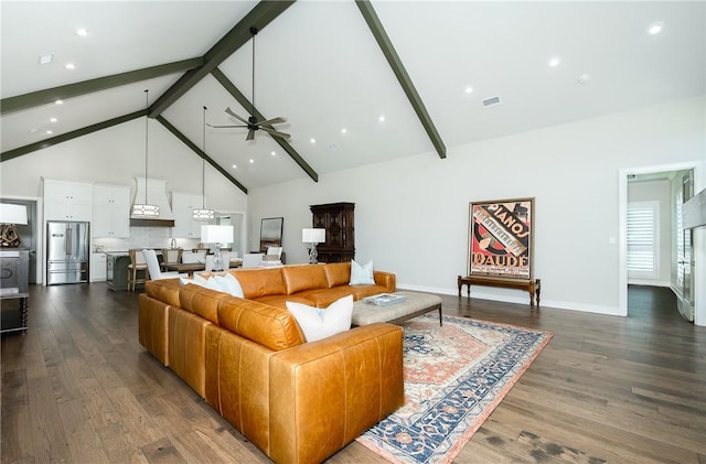 living room featuring visible vents, beamed ceiling, dark wood-type flooring, high vaulted ceiling, and a ceiling fan